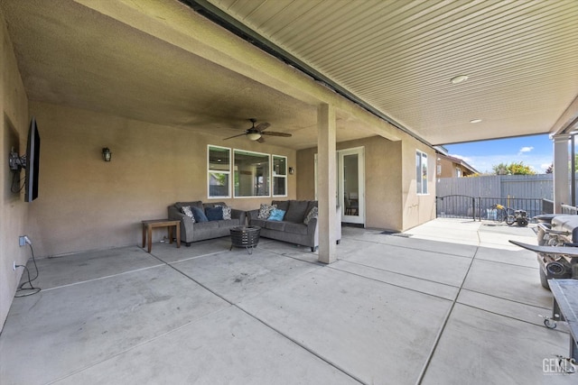view of patio / terrace featuring fence, an outdoor living space, and ceiling fan