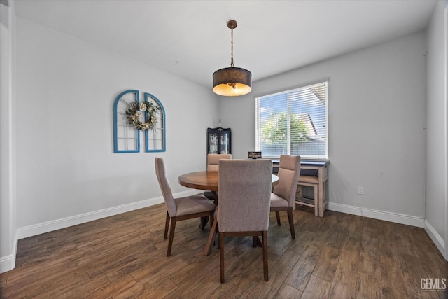 dining room featuring wood finished floors and baseboards