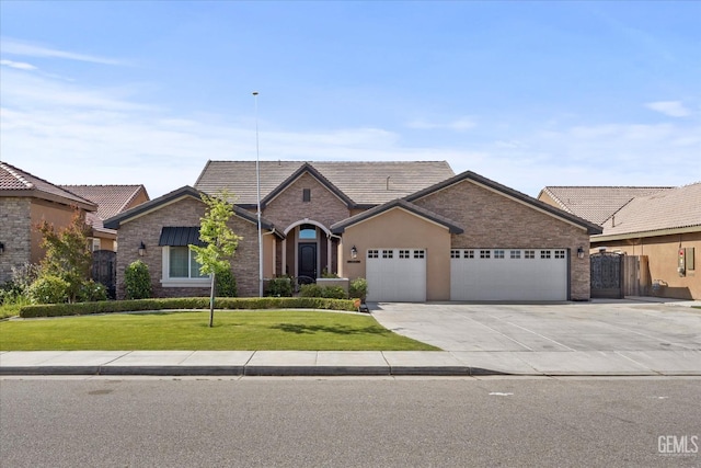 ranch-style house with a tile roof, concrete driveway, stone siding, an attached garage, and a front yard