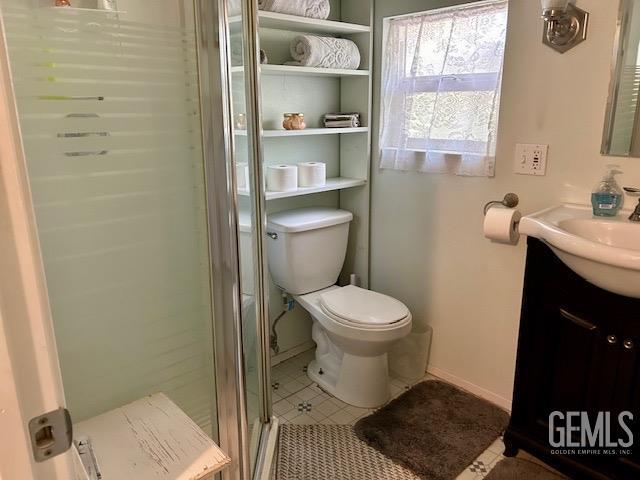 bathroom with vanity, toilet, and walk in shower