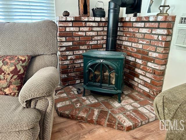 interior details featuring hardwood / wood-style flooring and a wood stove