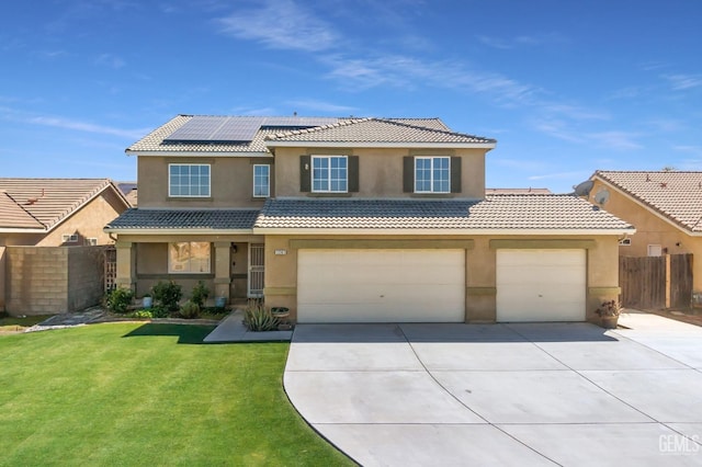 view of front of property with roof mounted solar panels, a tile roof, stucco siding, and fence