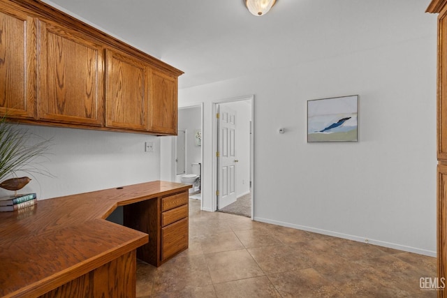 tiled office featuring built in study area and baseboards