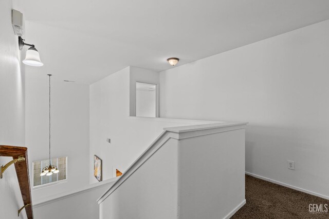 hall featuring carpet floors and baseboards