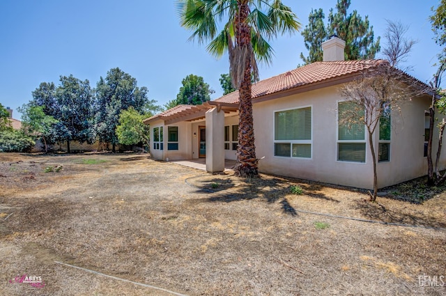 10102 Lace Cascade Ct, Bakersfield, CA 93311 - rear view of property with a tile roof, stucco siding, and a chimney