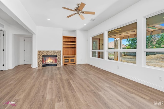10102 Lace Cascade Ct, Bakersfield, CA 93311 - unfurnished living room featuring wood finished floors, a glass covered fireplace, ceiling fan, and recessed lighting