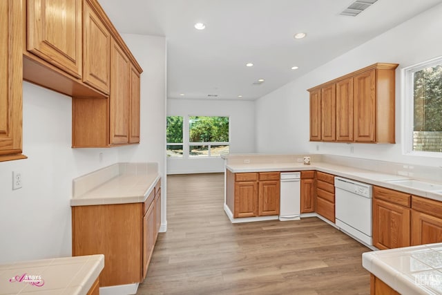 10102 Lace Cascade Ct, Bakersfield, CA 93311 - kitchen with dishwasher, light wood-style floors, a peninsula, tile counters, and recessed lighting