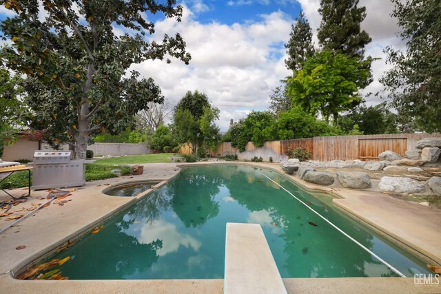 7408 Dos Rios Way, Bakersfield, CA 93309 - view of pool featuring a diving board, a patio, a fenced backyard, and a pool with connected hot tub