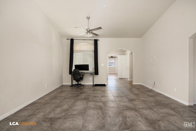 9404 Red Rock Creek Way, Bakersfield, CA 93311 - unfurnished living room with ceiling fan, arched walkways, an office area, and baseboards