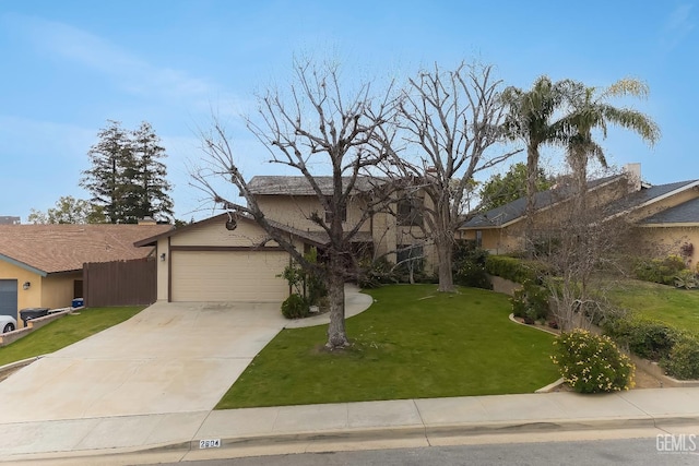 view of front of property with driveway, an attached garage, fence, and a front yard