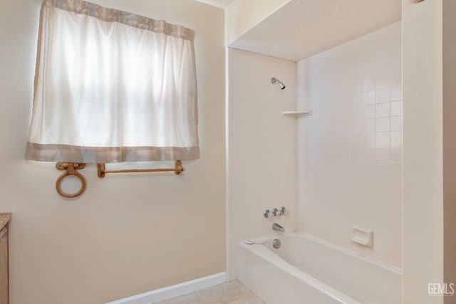 bathroom featuring tile patterned flooring, shower / bath combination, vanity, and baseboards