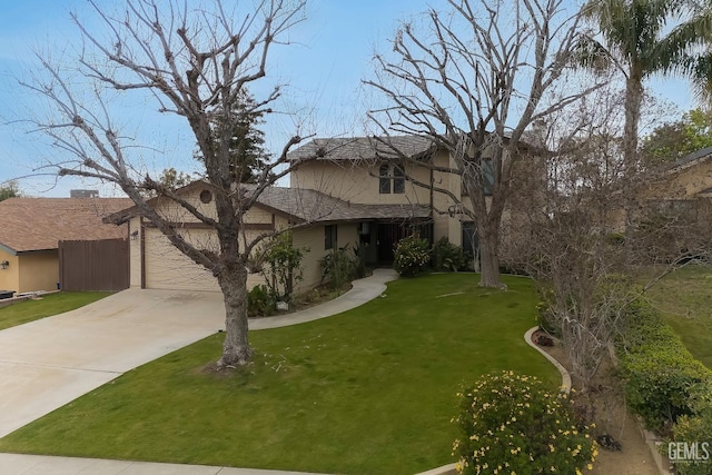 view of front of house featuring an attached garage, concrete driveway, and a front yard