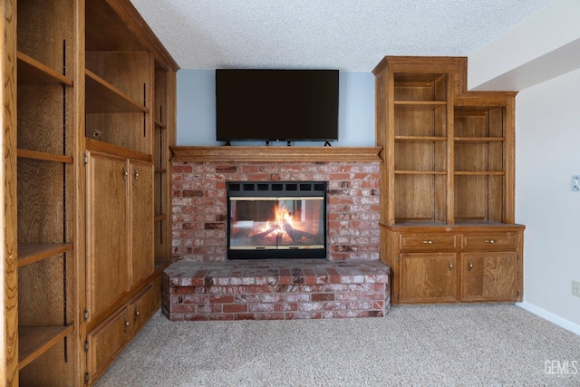 unfurnished living room featuring a brick fireplace, baseboards, a textured ceiling, and light colored carpet