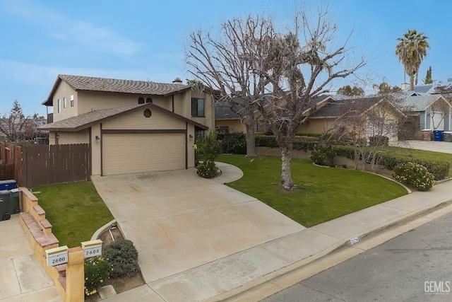 traditional-style home featuring driveway, a front lawn, an attached garage, and fence