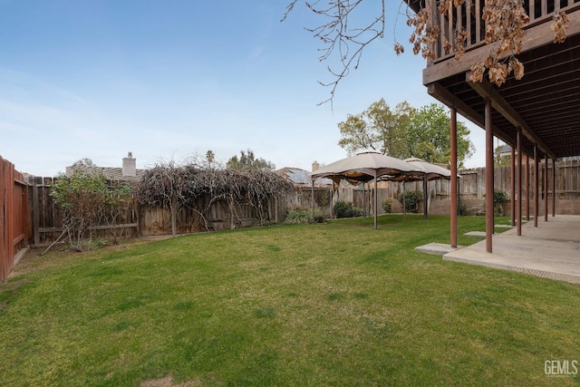 view of yard featuring a patio area and a fenced backyard