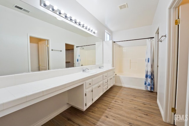 6720 Alderbrook Ln, Bakersfield, CA 93312 - full bath with wood finished floors, vanity, and shower / tub combo with curtain