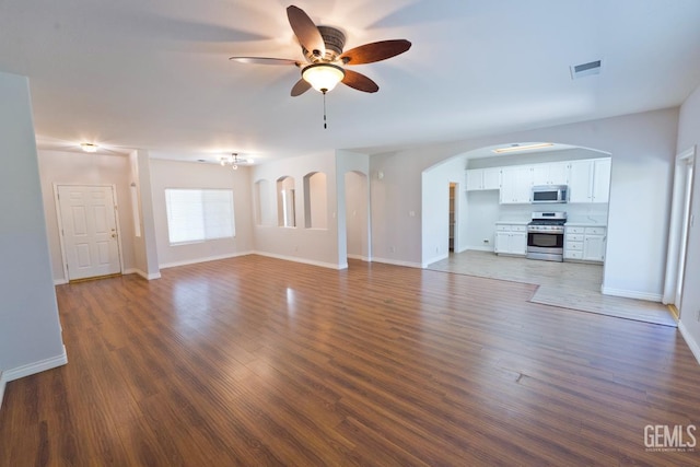 6720 Alderbrook Ln, Bakersfield, CA 93312 - unfurnished living room with ceiling fan, wood finished floors, and arched walkways