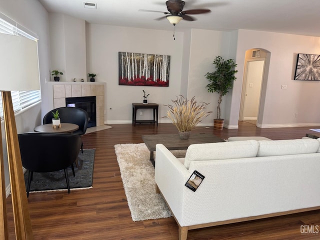 6720 Alderbrook Ln, Bakersfield, CA 93312 - living room with a ceiling fan, a fireplace, dark wood finished floors, and arched walkways