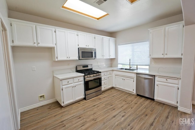 6720 Alderbrook Ln, Bakersfield, CA 93312 - kitchen with stainless steel appliances, light wood-style floors, and white cabinetry