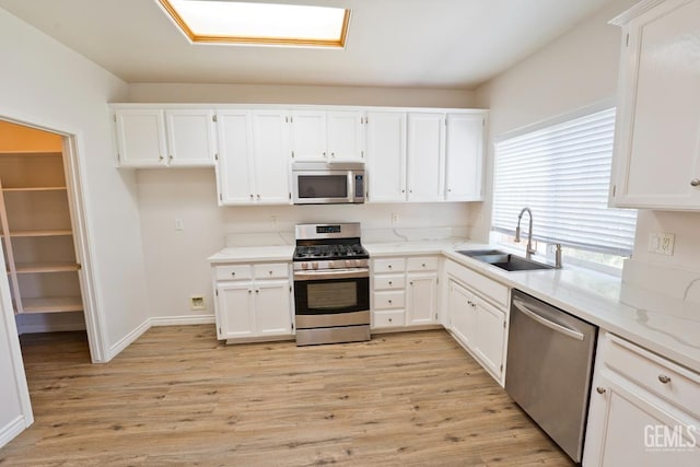 6720 Alderbrook Ln, Bakersfield, CA 93312 - kitchen featuring stainless steel appliances, white cabinetry, and light wood-style flooring