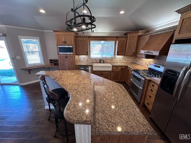 4049 Liz Dr, Bakersfield, CA 93312 - kitchen featuring appliances with stainless steel finishes, crown molding, custom range hood, a kitchen breakfast bar, and a kitchen island