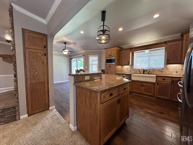 4049 Liz Dr, Bakersfield, CA 93312 - kitchen featuring appliances with stainless steel finishes, ornamental molding, backsplash, a center island, and a ceiling fan