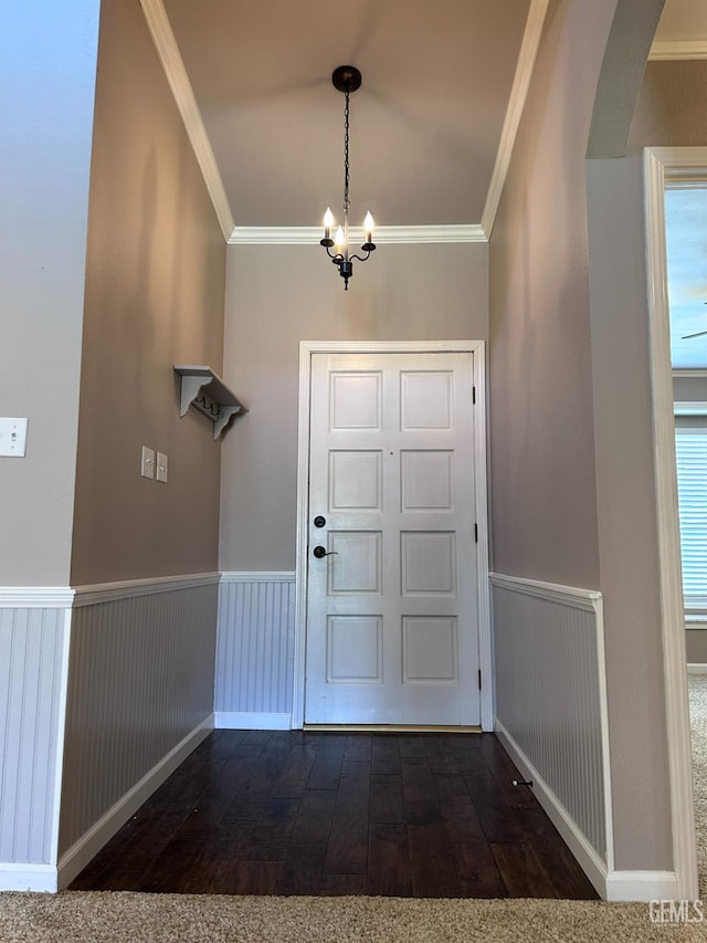 4049 Liz Dr, Bakersfield, CA 93312 - entryway with arched walkways, crown molding, dark wood-type flooring, a chandelier, and a wainscoted wall