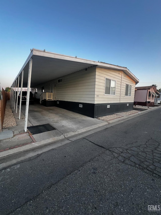4401 Hughes Ln Unit 148, Bakersfield, CA 93304 - view of home's exterior featuring an attached carport and crawl space