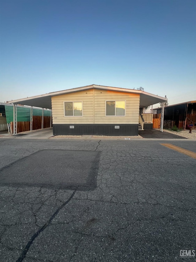 4401 Hughes Ln Unit 148, Bakersfield, CA 93304 - manufactured / mobile home featuring an attached carport and driveway