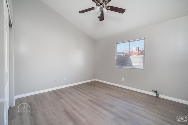 empty room with ceiling fan, light hardwood / wood-style flooring, and lofted ceiling