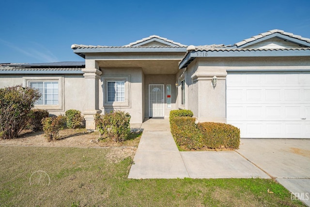 view of front of property featuring a garage and solar panels