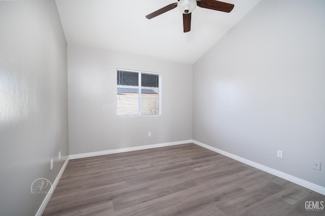 spare room featuring hardwood / wood-style flooring, ceiling fan, and vaulted ceiling