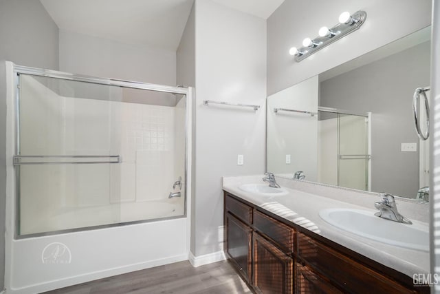 bathroom with vanity, combined bath / shower with glass door, and hardwood / wood-style floors