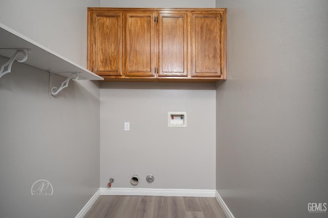 laundry area featuring washer hookup, hookup for a gas dryer, and light hardwood / wood-style floors