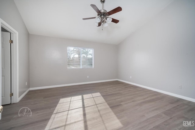 unfurnished bedroom featuring ceiling fan, hardwood / wood-style flooring, and vaulted ceiling