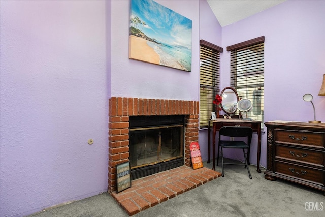 interior space featuring light colored carpet, vaulted ceiling, and a brick fireplace