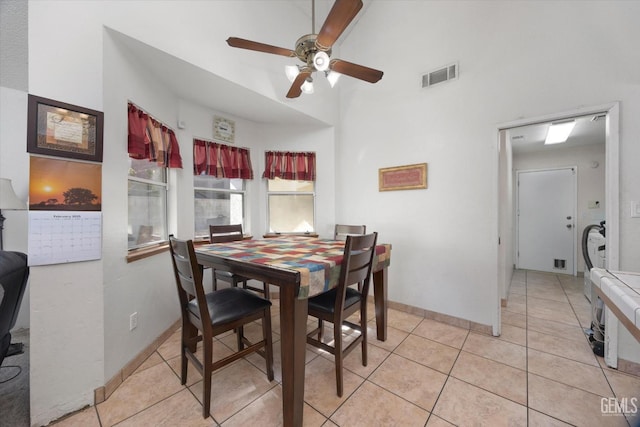 tiled dining space with ceiling fan