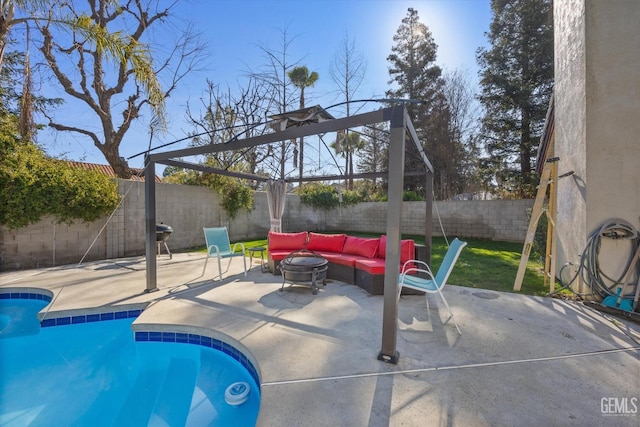 view of swimming pool featuring an outdoor living space with a fire pit and a patio area