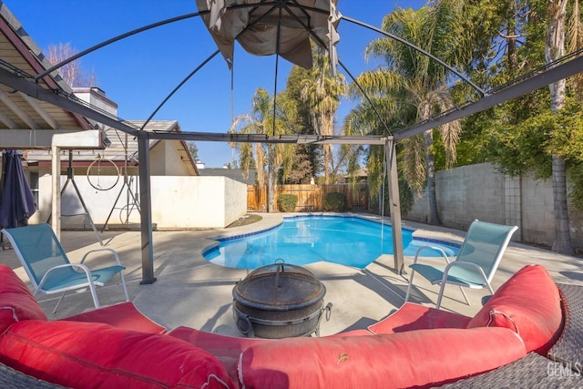 view of swimming pool featuring an outdoor fire pit