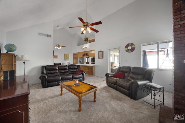 carpeted living room with high vaulted ceiling and ceiling fan