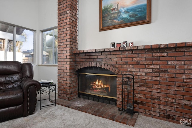 living room featuring a brick fireplace and carpet flooring