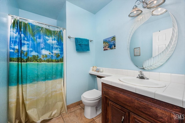 bathroom featuring tile patterned flooring, vanity, and toilet