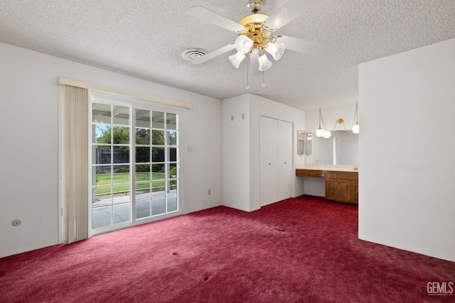 unfurnished bedroom with visible vents, a ceiling fan, access to outside, a textured ceiling, and dark carpet