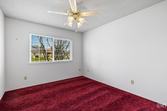 carpeted empty room featuring a ceiling fan and a textured ceiling