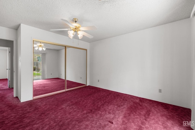 unfurnished bedroom featuring carpet flooring, a ceiling fan, a closet, and a textured ceiling