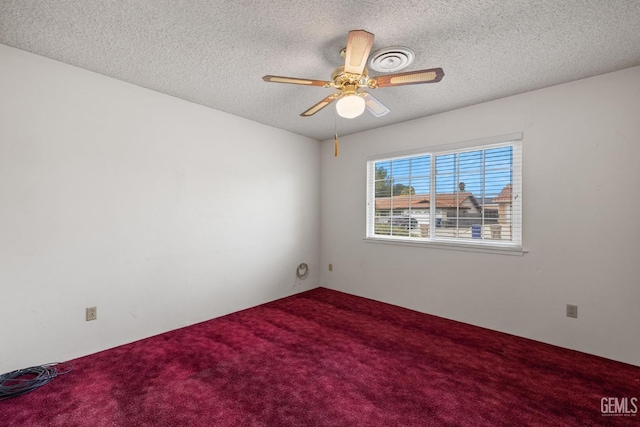 carpeted empty room with a textured ceiling and ceiling fan