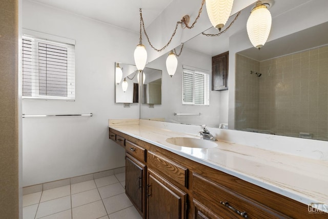 bathroom featuring tile patterned floors, tiled shower, and vanity