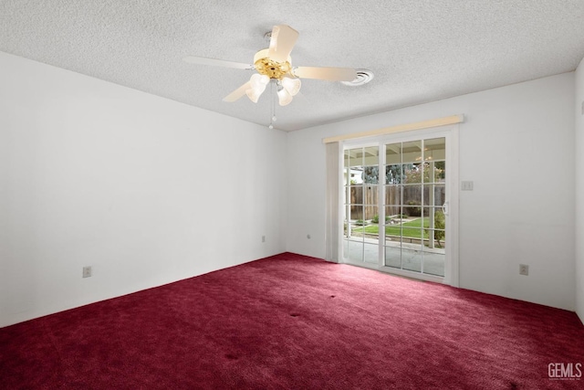 spare room featuring a textured ceiling, carpet, and a ceiling fan