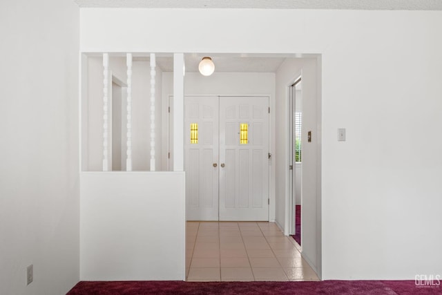 foyer featuring light colored carpet and light tile patterned flooring