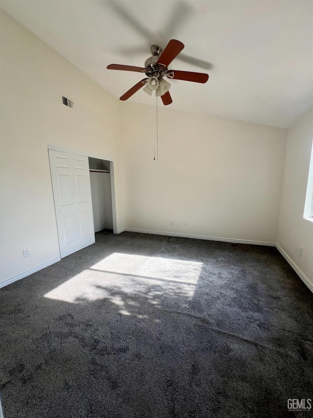107 Coverdale Ct, Bakersfield, CA 93307 - unfurnished bedroom with lofted ceiling, dark carpet, and ceiling fan